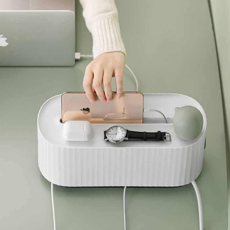 Organized desk with chargers contained in a cable management box